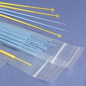 Sterile medical swabs and transparent plastic bags arranged on a blue surface.