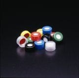 Assorted colorful poker chips arranged on a dark surface.